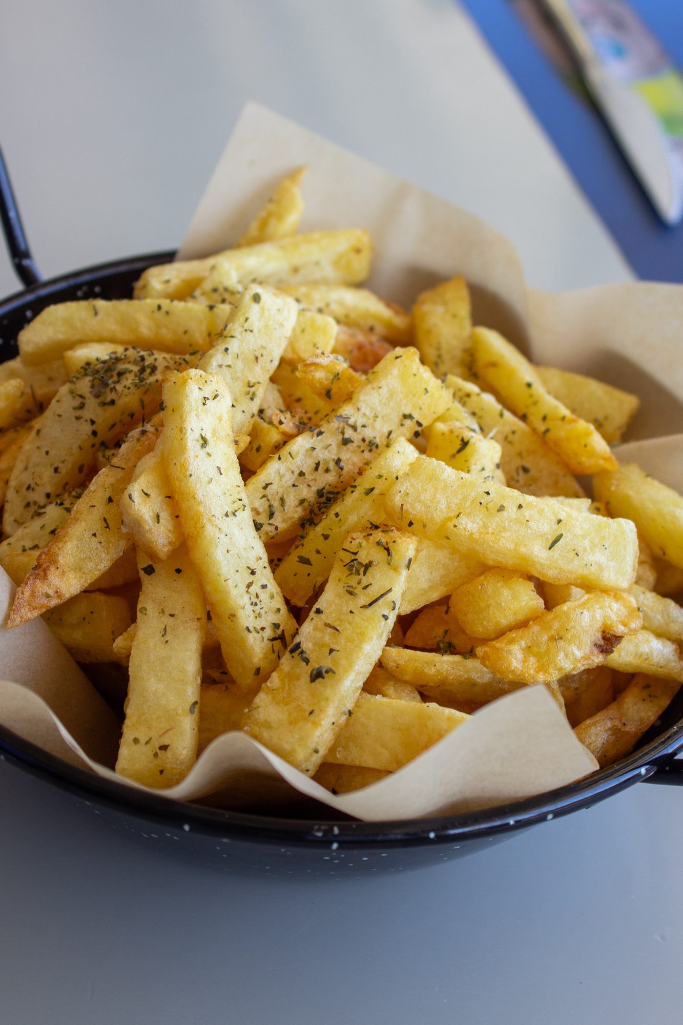 A bowl of chips dusted with oregano