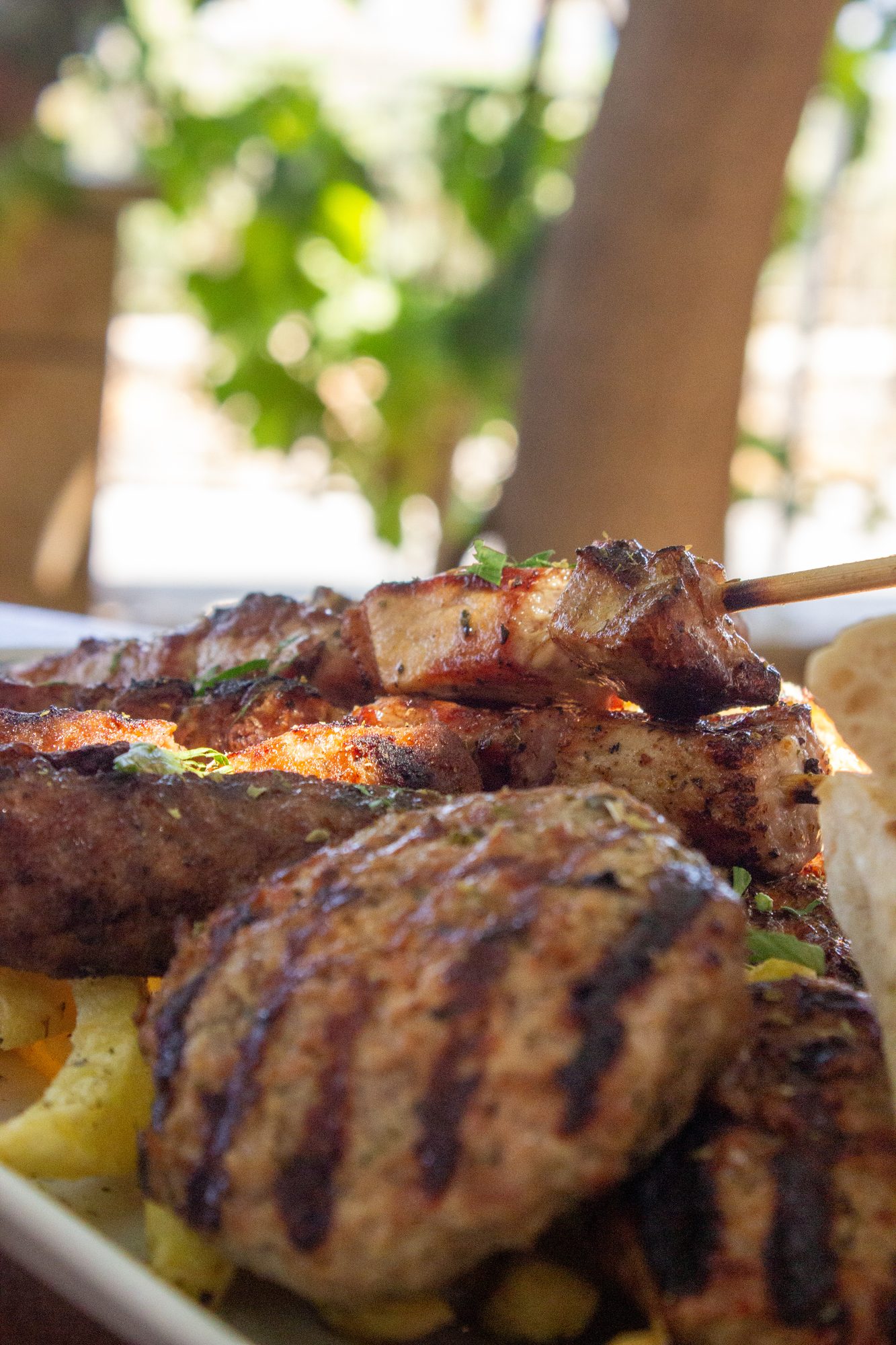 Grilled meat and potatoes on a green plate