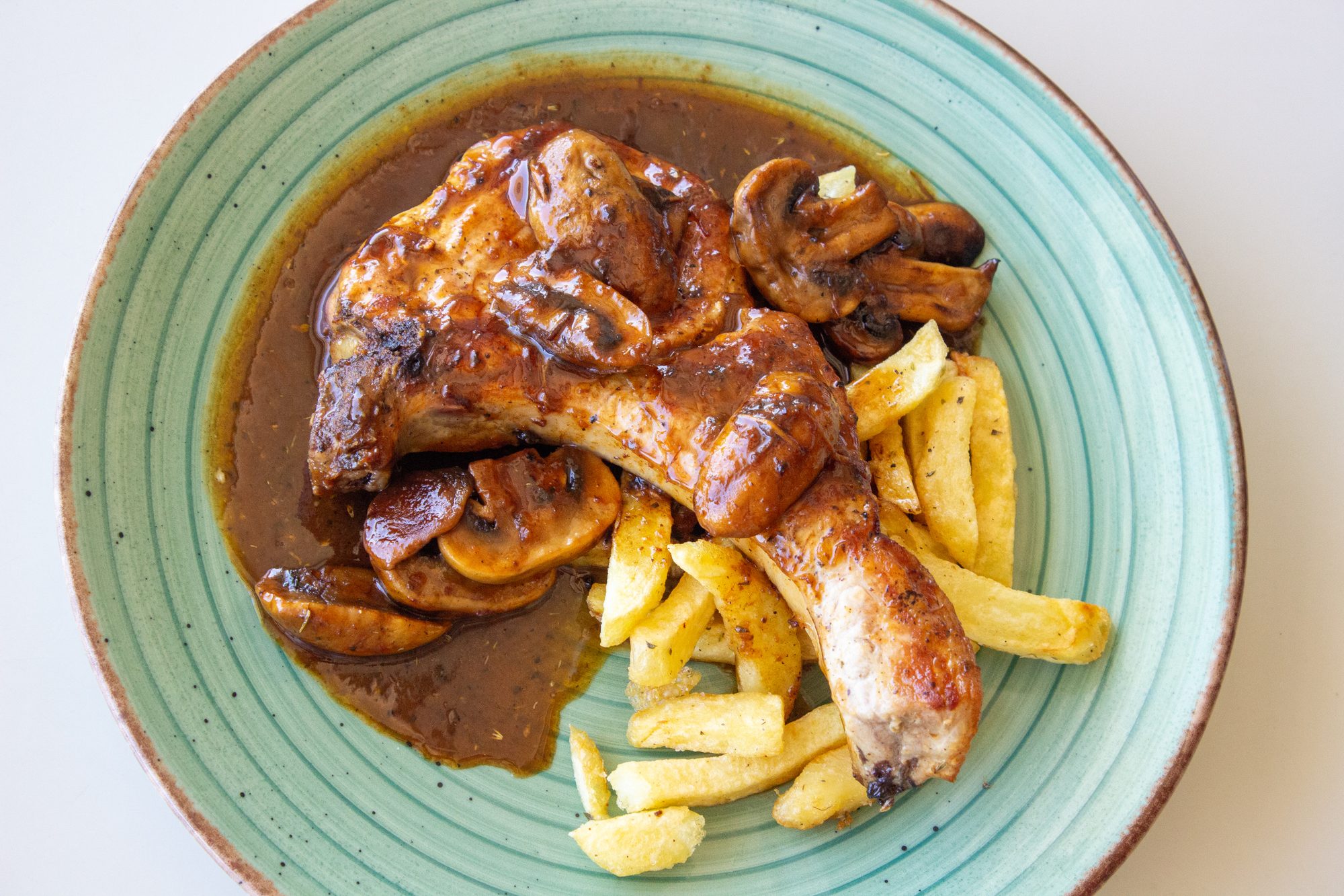 A slow cooked dish served with potatoes