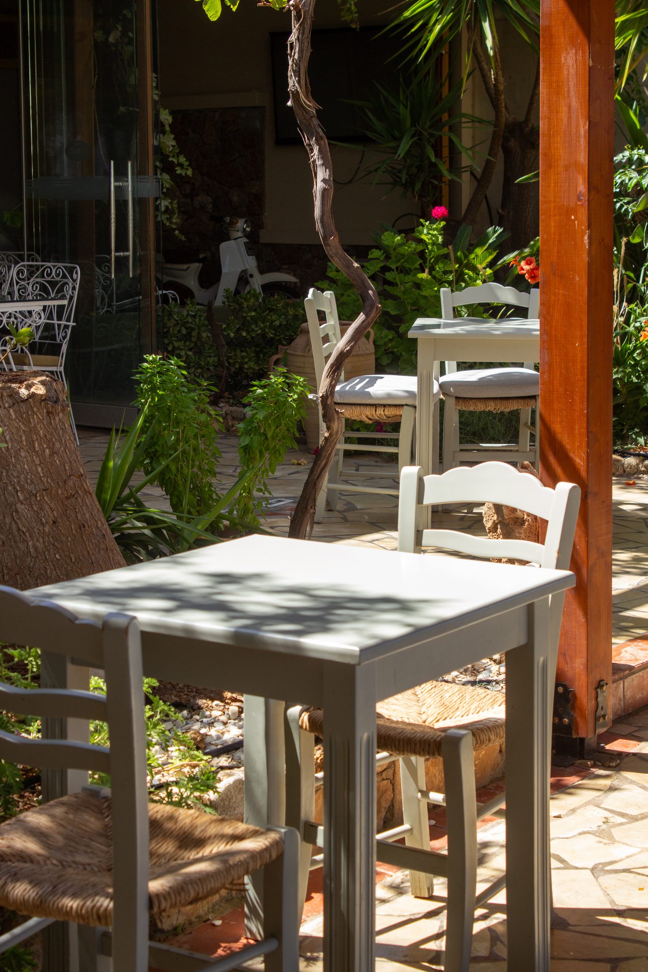 A white table set for lunch in the garden