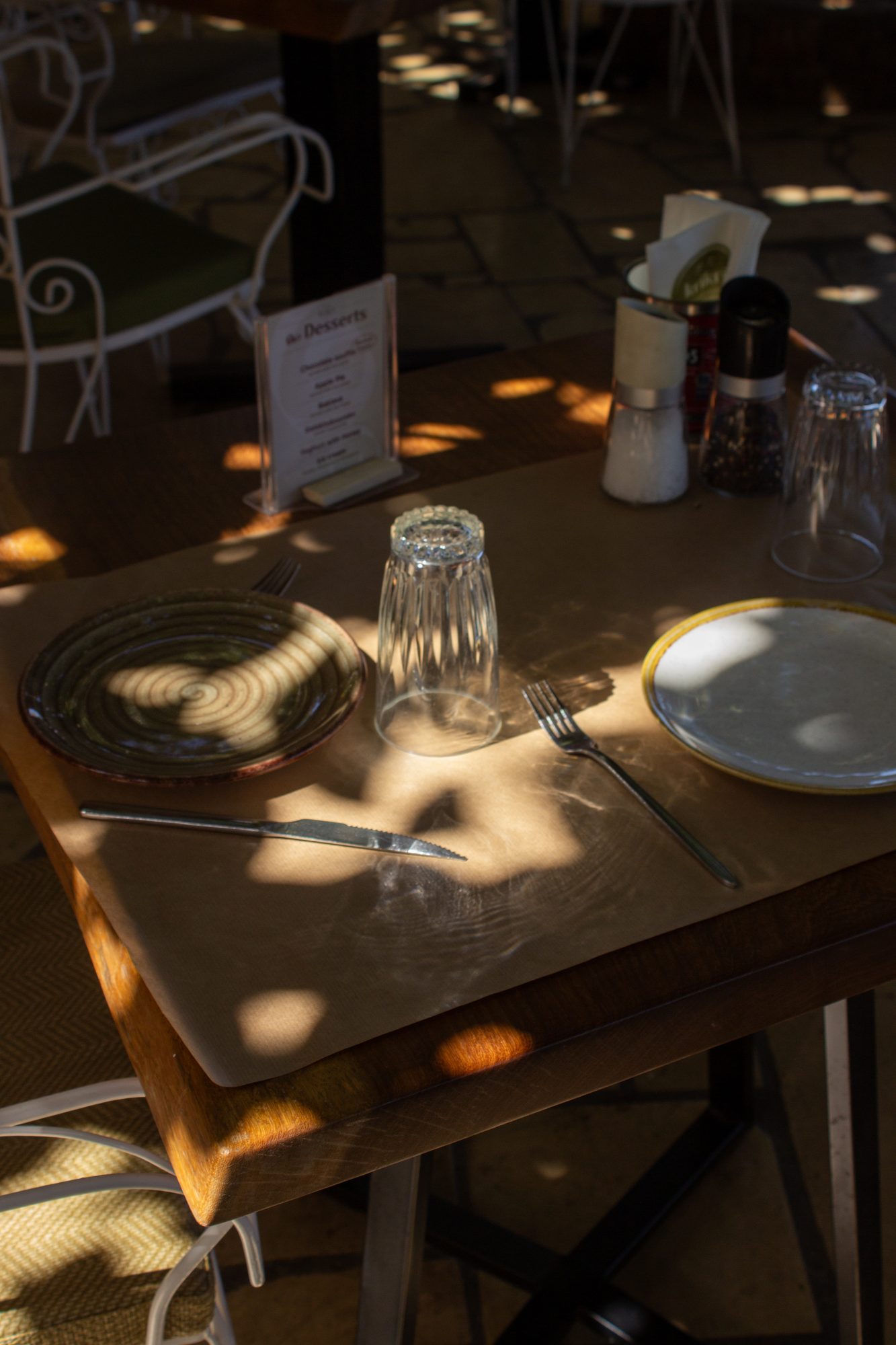 A place setting in dappled light
