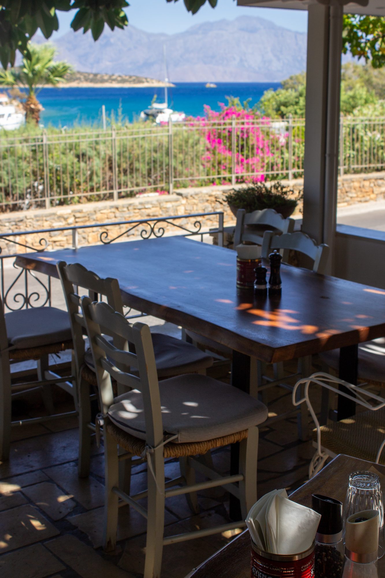 Long tables set on the terrace with the bay behind